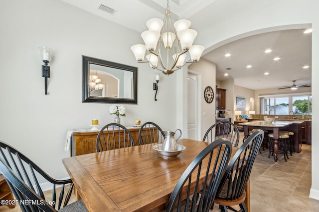 32479 Willow Parke Cir, Fernandina Beach, FL 32034 - dining area with arched walkways, recessed lighting, a chandelier, and ceiling fan