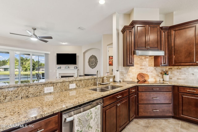 32479 Willow Parke Cir, Fernandina Beach, FL 32034 - kitchen with stainless steel dishwasher, a sink, ceiling fan, light stone countertops, and decorative backsplash