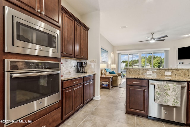 32479 Willow Parke Cir, Fernandina Beach, FL 32034 - kitchen with appliances with stainless steel finishes, a ceiling fan, light tile patterned floors, tasteful backsplash, and open floor plan