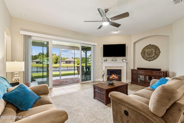 32479 Willow Parke Cir, Fernandina Beach, FL 32034 - living room featuring ceiling fan, light tile patterned flooring, and a glass covered fireplace