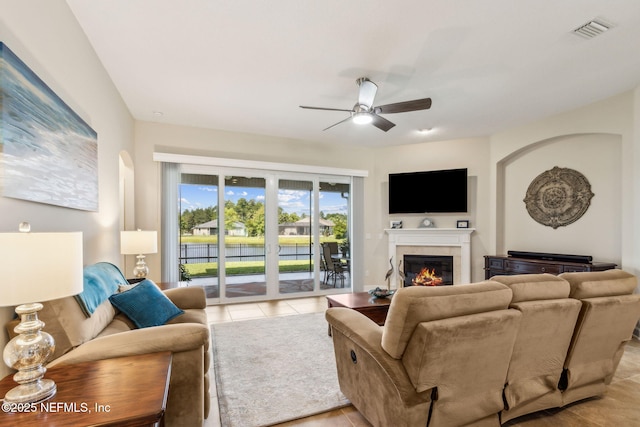 32479 Willow Parke Cir, Fernandina Beach, FL 32034 - living room featuring ceiling fan, a glass covered fireplace, and light tile patterned floors