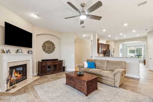 32479 Willow Parke Cir, Fernandina Beach, FL 32034 - living room featuring arched walkways, a ceiling fan, light tile patterned floors, a chandelier, and recessed lighting