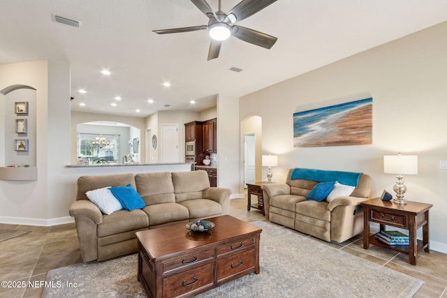 32479 Willow Parke Cir, Fernandina Beach, FL 32034 - living room with arched walkways, baseboards, ceiling fan, a chandelier, and recessed lighting