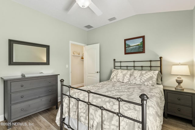 32479 Willow Parke Cir, Fernandina Beach, FL 32034 - bedroom featuring wood finished floors, vaulted ceiling, ceiling fan, and a walk in closet