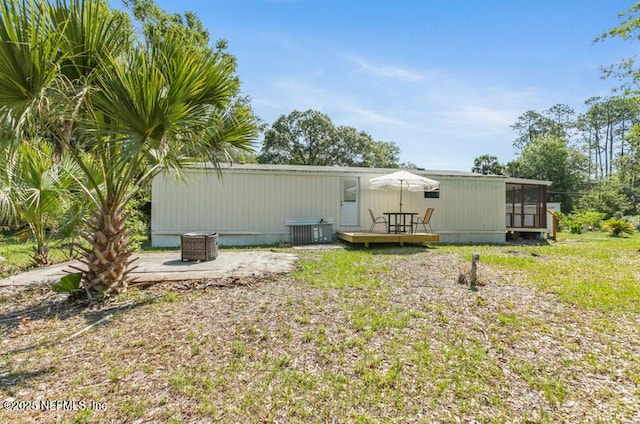 2022 Guava Ln, Bunnell, FL 32110 - back of property featuring a wooden deck and a sunroom