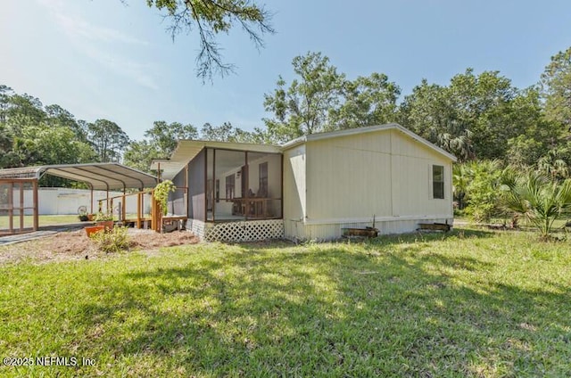 2022 Guava Ln, Bunnell, FL 32110 - view of home's exterior featuring a sunroom, a carport, and a lawn
