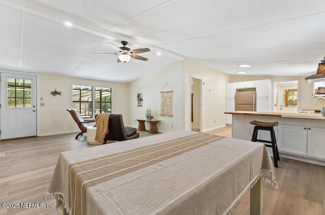 2022 Guava Ln, Bunnell, FL 32110 - bedroom with stainless steel fridge, light wood-style floors, multiple windows, and recessed lighting