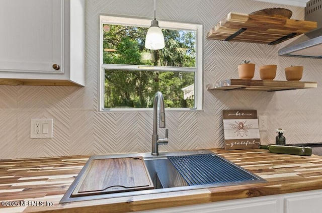 2022 Guava Ln, Bunnell, FL 32110 - kitchen featuring white cabinetry, butcher block counters, pendant lighting, a sink, and open shelves