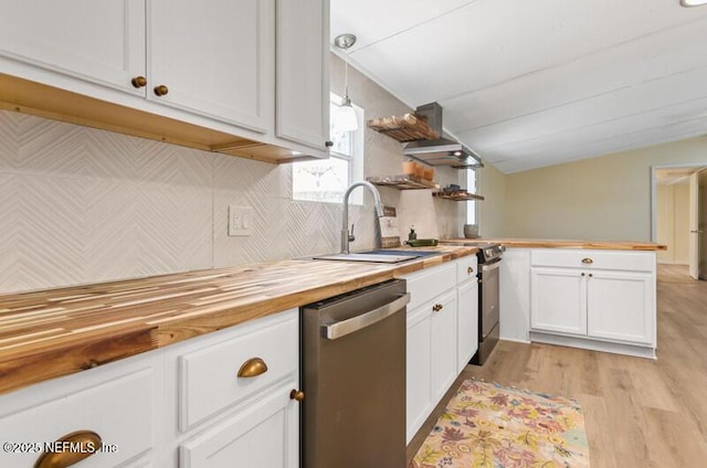 2022 Guava Ln, Bunnell, FL 32110 - kitchen with appliances with stainless steel finishes, butcher block counters, a peninsula, white cabinetry, and light wood-style flooring