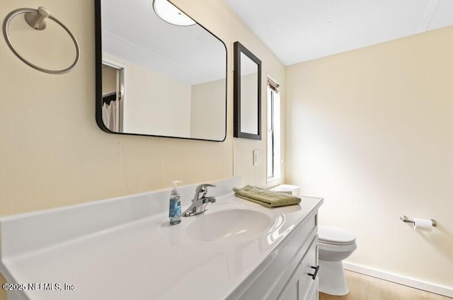 2022 Guava Ln, Bunnell, FL 32110 - bathroom featuring toilet, vanity, and baseboards