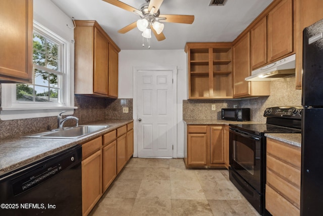 5372 Colonial Ave, Jacksonville, FL 32210 - kitchen with black appliances, under cabinet range hood, open shelves, and tasteful backsplash