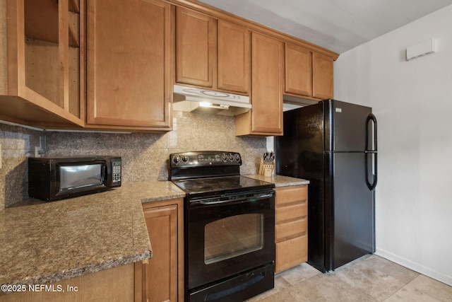 5372 Colonial Ave, Jacksonville, FL 32210 - kitchen with black appliances, under cabinet range hood, decorative backsplash, baseboards, and brown cabinets