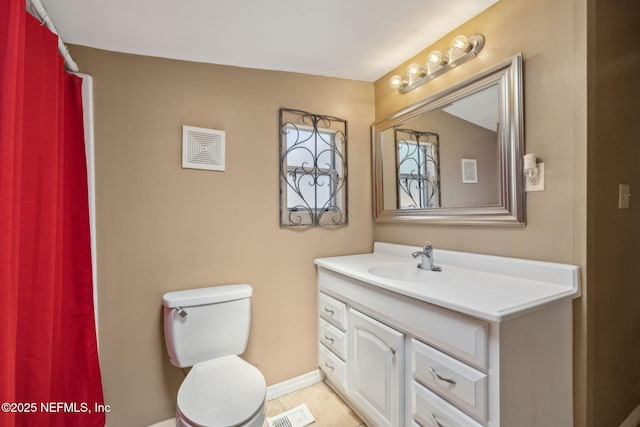 5372 Colonial Ave, Jacksonville, FL 32210 - bathroom with vanity, toilet, baseboards, and tile patterned floors