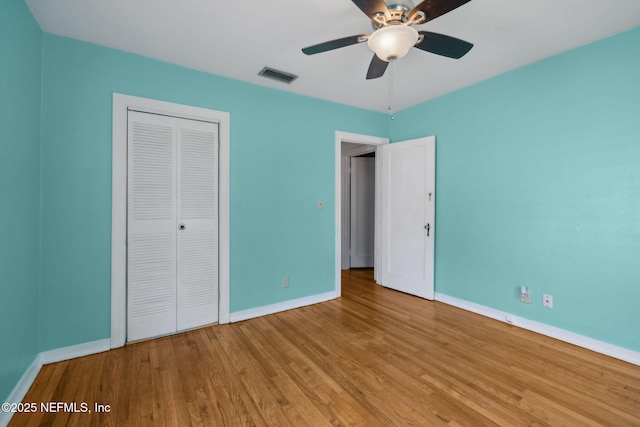 5372 Colonial Ave, Jacksonville, FL 32210 - unfurnished bedroom with baseboards, wood finished floors, a closet, and a ceiling fan