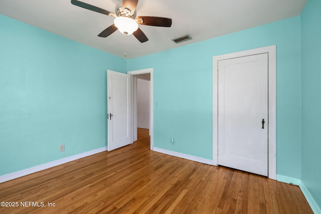 5372 Colonial Ave, Jacksonville, FL 32210 - unfurnished bedroom featuring baseboards, wood finished floors, a ceiling fan, and a closet