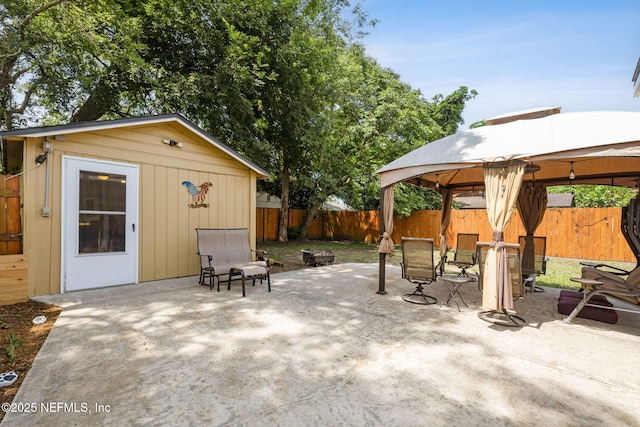 5372 Colonial Ave, Jacksonville, FL 32210 - fenced backyard with a gazebo, a patio, an outbuilding, and outdoor dining space