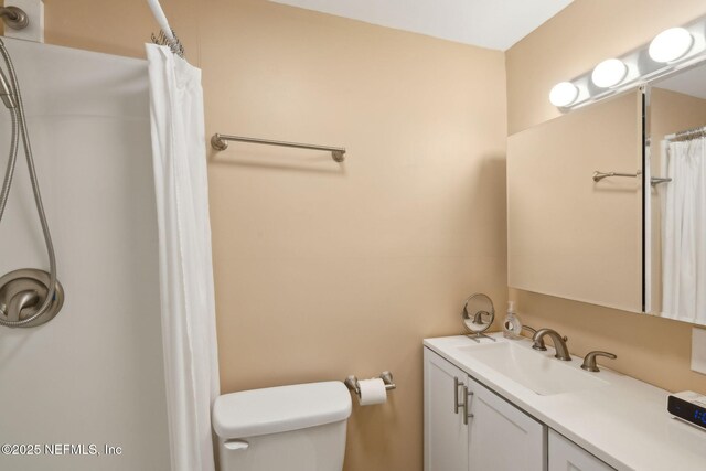 5372 Colonial Ave, Jacksonville, FL 32210 - full bath with vanity, toilet, and a shower with shower curtain