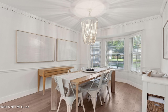 1908 Springbrook Rd, Fernandina Beach, FL 32034 - dining space featuring a chandelier, wood finished floors, baseboards, and ornamental molding