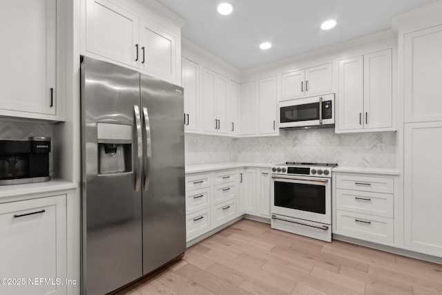 1908 Springbrook Rd, Fernandina Beach, FL 32034 - kitchen featuring white appliances, light countertops, white cabinetry, and recessed lighting