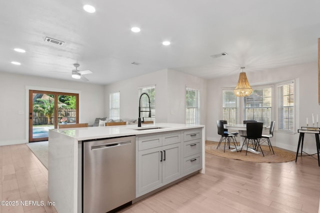 1908 Springbrook Rd, Fernandina Beach, FL 32034 - kitchen featuring stainless steel dishwasher, a sink, light countertops, light wood-style flooring, and a chandelier