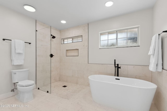 1908 Springbrook Rd, Fernandina Beach, FL 32034 - full bath with a freestanding bath, toilet, tiled shower, recessed lighting, and tile walls