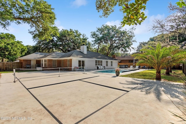 1908 Springbrook Rd, Fernandina Beach, FL 32034 - back of property with a patio area, brick siding, and a chimney