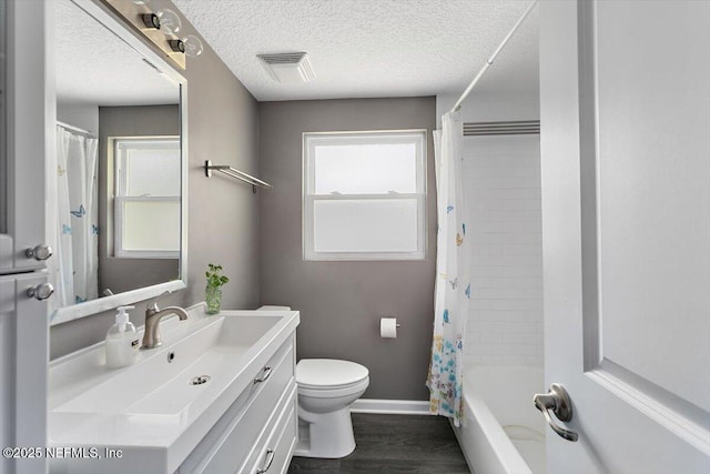 222 Acme St, Jacksonville, FL 32211 - bathroom with vanity, toilet, wood finished floors, baseboards, and a textured ceiling
