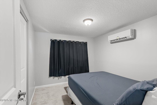 222 Acme St, Jacksonville, FL 32211 - carpeted bedroom featuring a wall unit AC, a textured ceiling, and baseboards