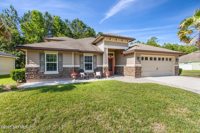79653 Plummers Creek Dr, Yulee, FL 32097 - prairie-style house with a garage, stone siding, driveway, and a front yard