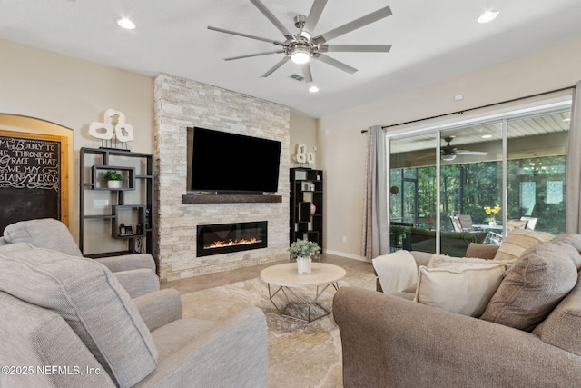79653 Plummers Creek Dr, Yulee, FL 32097 - living room featuring ceiling fan, a fireplace, recessed lighting, and baseboards