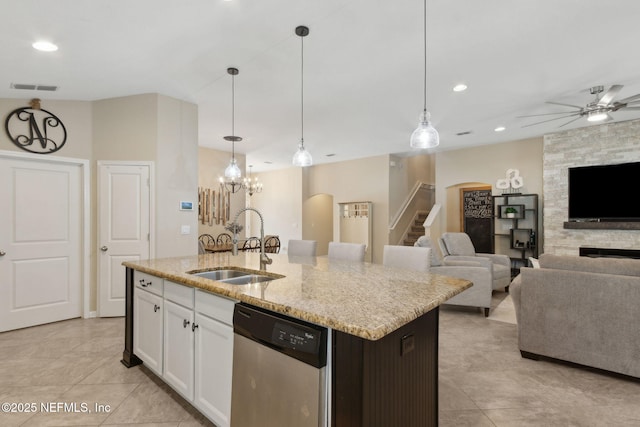 79653 Plummers Creek Dr, Yulee, FL 32097 - kitchen featuring dishwasher, a sink, light tile patterned flooring, light stone counters, and white cabinetry