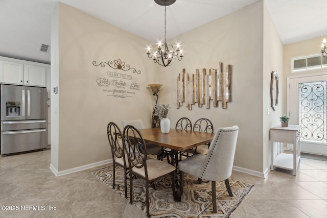 79653 Plummers Creek Dr, Yulee, FL 32097 - dining area featuring a chandelier, baseboards, light tile patterned floors, and vaulted ceiling