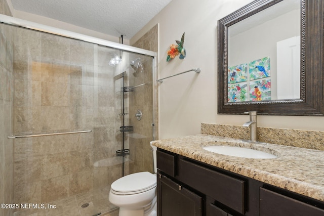 79653 Plummers Creek Dr, Yulee, FL 32097 - bathroom with vanity, toilet, a stall shower, and a textured ceiling