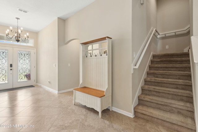 79653 Plummers Creek Dr, Yulee, FL 32097 - foyer entrance featuring stairway, a high ceiling, a chandelier, baseboards, and light tile patterned floors