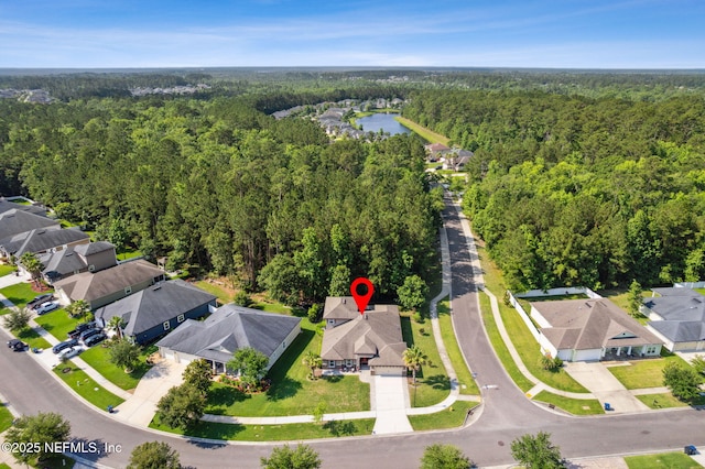 79653 Plummers Creek Dr, Yulee, FL 32097 - aerial view of property's location with a heavily wooded area, nearby suburban area, and a large body of water