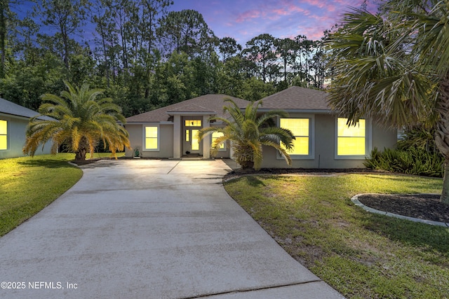 2097 Frogmore Dr, Middleburg, FL 32068 - view of front of home featuring concrete driveway, stucco siding, a lawn, and a shingled roof
