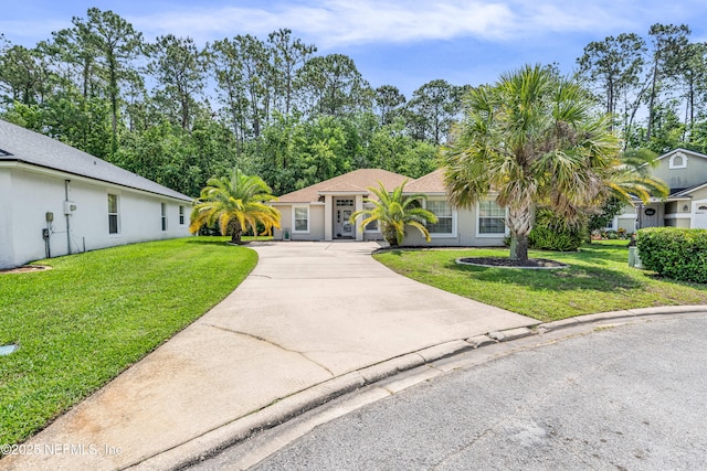 2097 Frogmore Dr, Middleburg, FL 32068 - view of front facade featuring driveway, a front yard, and stucco siding