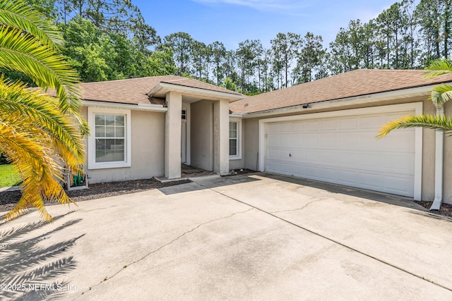 2097 Frogmore Dr, Middleburg, FL 32068 - view of front of home featuring stucco siding, concrete driveway, an attached garage, and a shingled roof