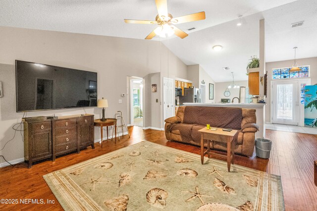 2097 Frogmore Dr, Middleburg, FL 32068 - living room featuring wood finished floors, lofted ceiling, a ceiling fan, and baseboards