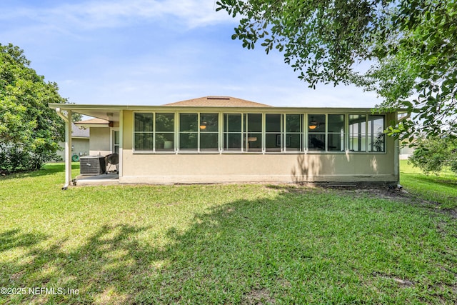 2097 Frogmore Dr, Middleburg, FL 32068 - rear view of house featuring central AC unit, a lawn, stucco siding, and a sunroom