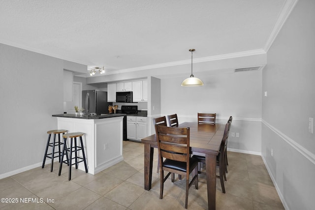 430 Timberwalk Ct Unit 1023, Ponte Vedra Beach, FL 32082 - dining room featuring ornamental molding, a textured ceiling, light tile patterned floors, and baseboards