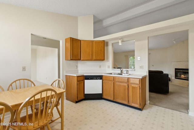 4585 Arrow Wind Ln, Jacksonville, FL 32258 - kitchen with dishwasher, a sink, light countertops, vaulted ceiling, and brown cabinets