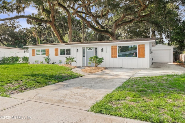 1129 Sebago Ave N, Jacksonville, FL 32233 - single story home featuring concrete driveway, board and batten siding, a front yard, and a garage