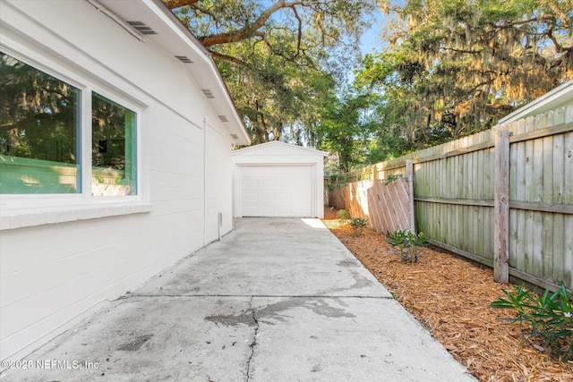 1129 Sebago Ave N, Jacksonville, FL 32233 - view of side of home with an outdoor structure, driveway, and a garage