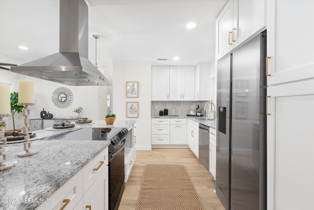 1129 Sebago Ave N, Jacksonville, FL 32233 - kitchen featuring stainless steel appliances, island exhaust hood, white cabinets, light stone counters, and light wood-style flooring
