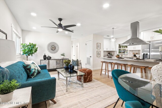1129 Sebago Ave N, Jacksonville, FL 32233 - living area with light wood finished floors, recessed lighting, a ceiling fan, and baseboards