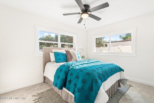 1129 Sebago Ave N, Jacksonville, FL 32233 - carpeted bedroom featuring baseboards and a ceiling fan