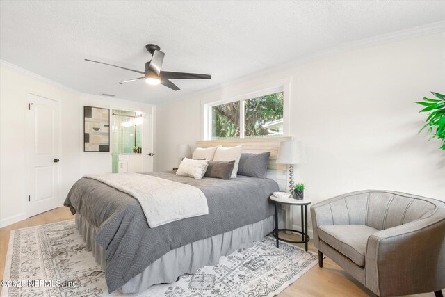 1129 Sebago Ave N, Jacksonville, FL 32233 - bedroom featuring wood finished floors, ornamental molding, a textured ceiling, and ceiling fan