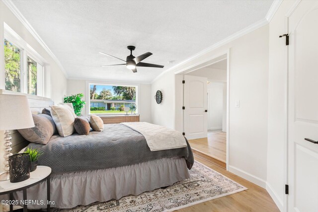 1129 Sebago Ave N, Jacksonville, FL 32233 - bedroom with light wood-style floors, ornamental molding, baseboards, and a ceiling fan