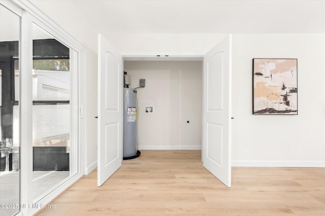 1129 Sebago Ave N, Jacksonville, FL 32233 - hallway with electric water heater, light wood-style floors, and baseboards